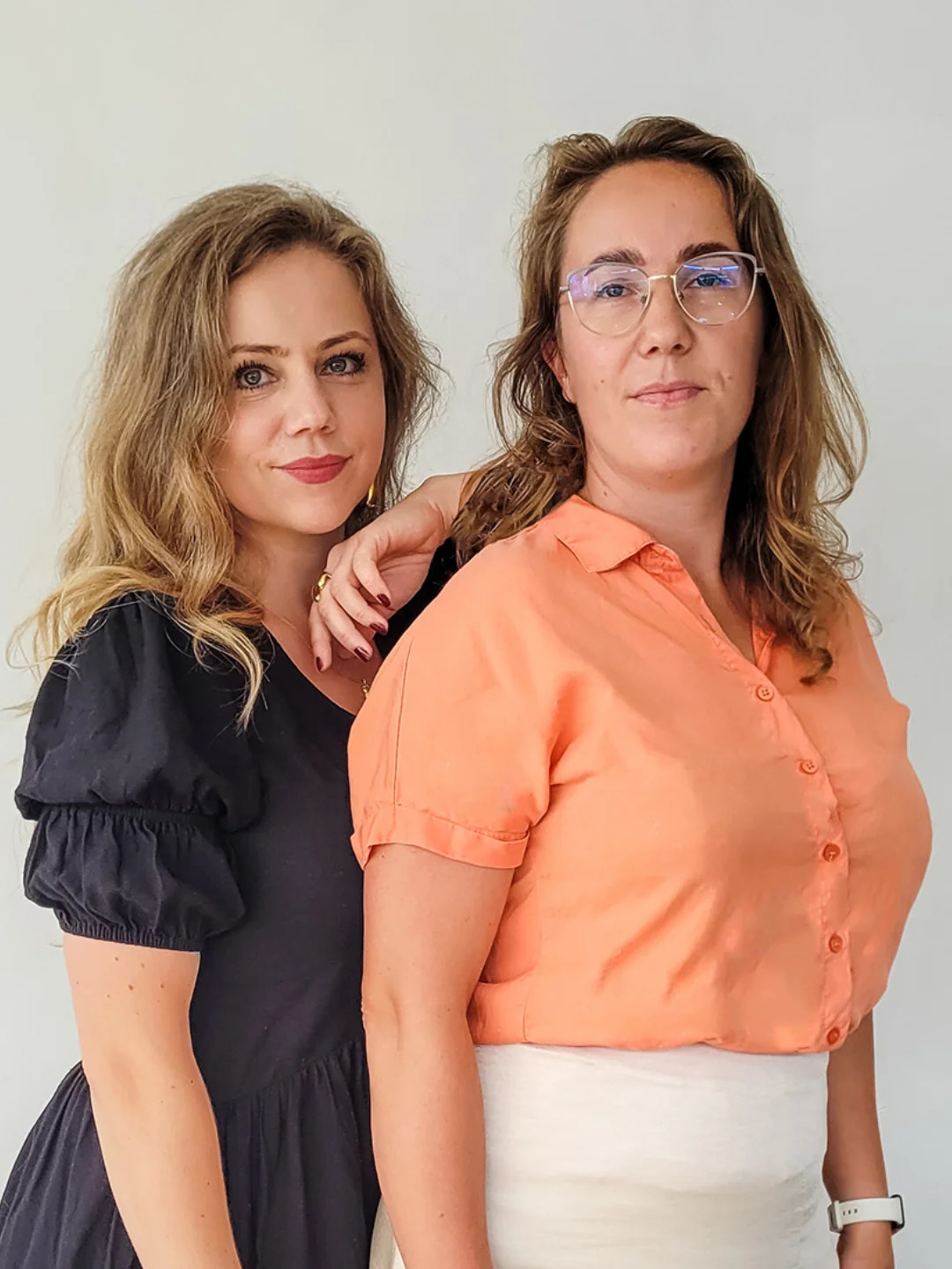 Two women from the TWÓR Association team posing together against a light background
